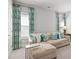 Comfortable living room features a plush sectional sofa with decorative pillows and light-filled windows with patterned curtains at 74 Academy St, Alpharetta, GA 30009