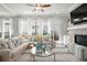 Cozy living room with comfortable seating, a fireplace, and large windows for natural light at 74 Academy St, Alpharetta, GA 30009