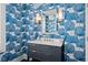 Chic powder room showcases blue wallpaper, stylish vanity, and modern lighting at 74 Academy St, Alpharetta, GA 30009