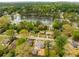Aerial view of a home with a large backyard and mature trees near a lake at 2374 Marion Cir, Decatur, GA 30032
