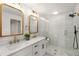 Elegant bathroom showcasing double sink vanity and marble-tiled shower with glass door at 2374 Marion Cir, Decatur, GA 30032
