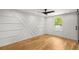 Bright bedroom with hardwood floors, stylish accent wall, and modern ceiling fan at 2374 Marion Cir, Decatur, GA 30032