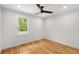 A sun-filled bedroom features hardwood floors and a window showcasing the outdoors at 2374 Marion Cir, Decatur, GA 30032