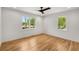 Sun-lit bedroom showcasing hardwood floors and dual windows at 2374 Marion Cir, Decatur, GA 30032