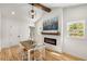 Dining room with modern light fixture, fireplace, and natural light at 2374 Marion Cir, Decatur, GA 30032