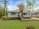 Charming home with light blue siding, wooden shutters, landscaped front yard, and inviting curb appeal at 2374 Marion Cir, Decatur, GA 30032