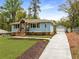 Charming light blue home with lovely landscaping, craftsman details, and a detached two-car garage at 2374 Marion Cir, Decatur, GA 30032