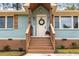 Inviting front porch with wood accents, a charming wreath, and a freshly painted door, creating a warm welcome at 2374 Marion Cir, Decatur, GA 30032