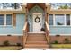 Charming front porch with wooden railing, planters and welcoming decor at 2374 Marion Cir, Decatur, GA 30032