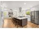 Bright, open kitchen with stainless steel appliances, a large island, and hardwood floors at 2374 Marion Cir, Decatur, GA 30032