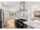 Open kitchen with island gas range, stainless appliances, and hardwood floors at 2374 Marion Cir, Decatur, GA 30032