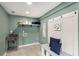 Well-organized laundry room with a stainless steel sink, storage shelves, and a bench at 2374 Marion Cir, Decatur, GA 30032