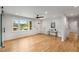 Sunlit living room featuring beautiful hardwood floors, a ceiling fan, and an entry door at 2374 Marion Cir, Decatur, GA 30032