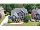 Aerial view of the brick home with manicured landscaping, a grey roof, and lush surroundings in a residential neighborhood at 3237 Birkdale Ave, Duluth, GA 30097