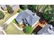 Aerial shot of a brick home with a grey roof surrounded by green lawns, mature trees, and neighborhood residences at 3237 Birkdale Ave, Duluth, GA 30097
