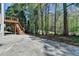 A backyard featuring a stone patio and a deck overlooking a wooded area providing a private and tranquil outdoor space at 3237 Birkdale Ave, Duluth, GA 30097