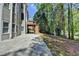 Stone patio and deck with stairs leading to a private wooded area, offering a seamless transition to nature at 3237 Birkdale Ave, Duluth, GA 30097