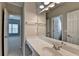 Bathroom with a long white countertop, large mirror, and doorways that let in natural light at 3237 Birkdale Ave, Duluth, GA 30097