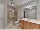 Bathroom featuring a glass-enclosed shower, toilet, vanity with sink and large mirror at 3237 Birkdale Ave, Duluth, GA 30097