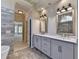 Bathroom featuring double sink vanity, marble countertop, and modern lighting at 3237 Birkdale Ave, Duluth, GA 30097