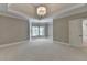 Spacious bedroom with elegant chandelier and a charming bay window nook, next to a doorway leading to other rooms at 3237 Birkdale Ave, Duluth, GA 30097