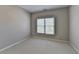 An empty carpeted bedroom with neutral walls and a window offering ample natural light at 3237 Birkdale Ave, Duluth, GA 30097
