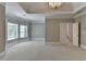 Bright and airy bedroom with tray ceilings, elegant chandelier, bay window, and a doorway leading to other rooms at 3237 Birkdale Ave, Duluth, GA 30097