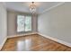Bright bedroom with hardwood floors, natural light, and elegant chandelier at 3237 Birkdale Ave, Duluth, GA 30097
