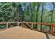 Spacious wooden deck with black metal railing offering a private outdoor retreat overlooking a wooded backyard at 3237 Birkdale Ave, Duluth, GA 30097