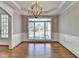 Elegant dining area with detailed trim, hardwood floors, and chandelier at 3237 Birkdale Ave, Duluth, GA 30097