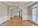 Bright dining room with hardwood flooring, decorative moldings, and large window showcasing natural light at 3237 Birkdale Ave, Duluth, GA 30097