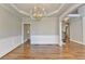 Elegant dining room featuring hardwood floors, wainscoting, tray ceiling, and stylish chandelier at 3237 Birkdale Ave, Duluth, GA 30097