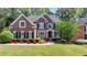 Beautiful brick home with manicured lawn and colorful flowerbeds at 3237 Birkdale Ave, Duluth, GA 30097