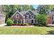 Beautiful brick home with manicured lawn and colorful flowerbeds at 3237 Birkdale Ave, Duluth, GA 30097