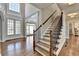 Elegant foyer with hardwood floors, staircase with iron railing, and natural light at 3237 Birkdale Ave, Duluth, GA 30097