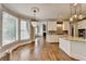 Kitchen featuring an island, hardwood floors, pendant lights, and large windows at 3237 Birkdale Ave, Duluth, GA 30097