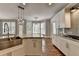 Spacious kitchen featuring stainless steel appliances, granite counters, farmhouse sink and view to sunroom at 3237 Birkdale Ave, Duluth, GA 30097