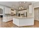 Bright kitchen features white cabinets, stainless steel appliances, granite countertops, and hardwood floors at 3237 Birkdale Ave, Duluth, GA 30097