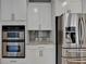 Bright kitchen showcases stainless steel appliances, white cabinets, and built-in oven at 3237 Birkdale Ave, Duluth, GA 30097