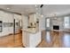 Bright kitchen features stainless steel appliances, granite counters, white cabinets and adjacent living space at 3237 Birkdale Ave, Duluth, GA 30097