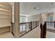 Bright upstairs landing featuring built-in shelves, carpet, and railing overlooking foyer at 3237 Birkdale Ave, Duluth, GA 30097