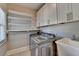 Modern laundry room with stainless steel washer and dryer, sink, and ample cabinet space at 3237 Birkdale Ave, Duluth, GA 30097
