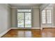 Bright, airy living room with hardwood floors, large windows, and a view of the outdoors at 3237 Birkdale Ave, Duluth, GA 30097
