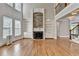 Bright living room with hardwood floors, stone fireplace, built-in bookshelves, and large windows at 3237 Birkdale Ave, Duluth, GA 30097