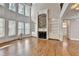 Bright living room with hardwood floors, stone fireplace, built-in bookshelves, and large windows at 3237 Birkdale Ave, Duluth, GA 30097