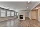Spacious living room with wood floors, large windows, and a cozy fireplace with white brick surround at 3237 Birkdale Ave, Duluth, GA 30097