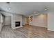 Open-concept living room with wood flooring and a brick fireplace near stairway at 3237 Birkdale Ave, Duluth, GA 30097