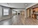 Open-concept living room with wood floors, large windows, and a cozy fireplace with wet bar at 3237 Birkdale Ave, Duluth, GA 30097