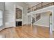 Living room featuring a stone fireplace, hardwood floors, and a staircase to the upper level at 3237 Birkdale Ave, Duluth, GA 30097