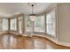 Bright and open living room features large windows, a chandelier, and hardwood floors at 3237 Birkdale Ave, Duluth, GA 30097